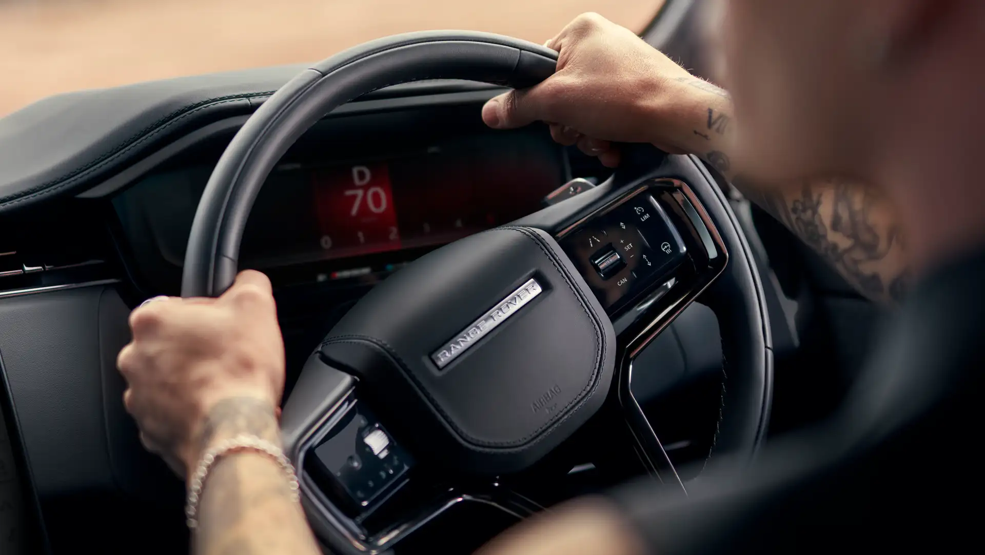 The steering wheel and interior of a Range Rover Sport.